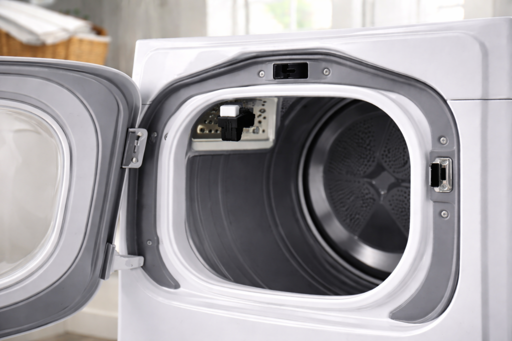 Location of the dryer door switch inside the front frame near the door latch