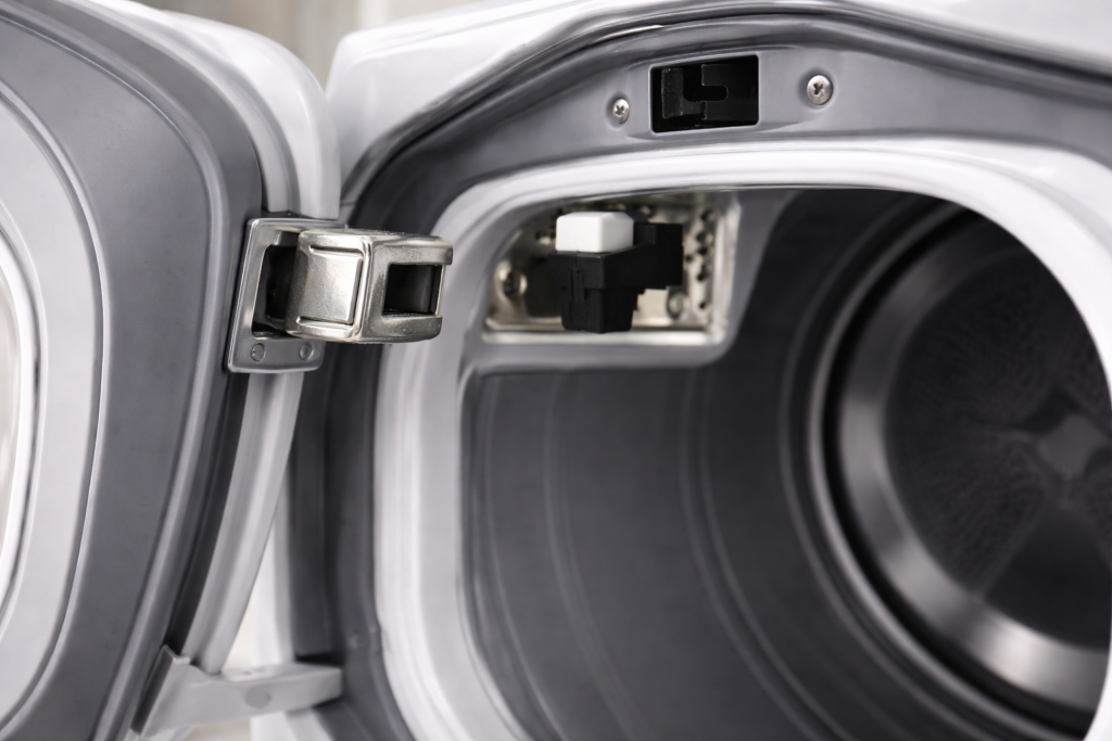 Dryer door latch aligning with the door switch inside the dryer frame